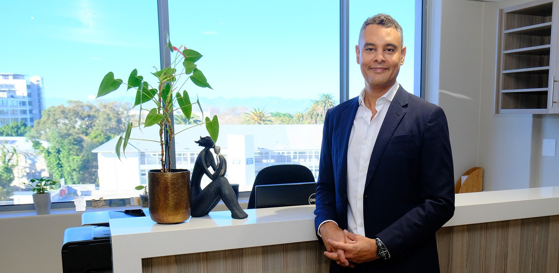 Dr Gary Groenewald standing at the reception of his Claremont practice