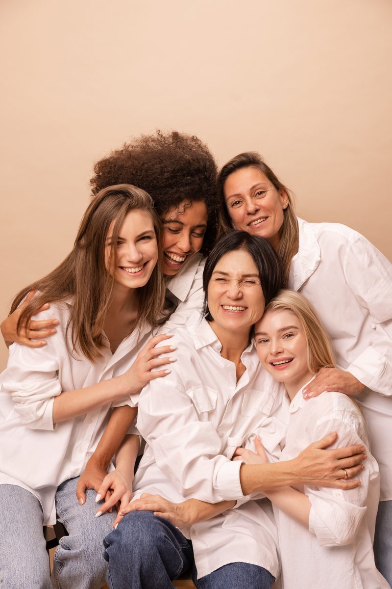 A group of women of different ages and backgrounds laughing together